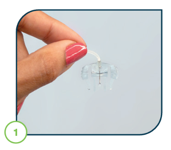 hand_holding_connector_needle_upside_down_with_insulin_drops_at_tip_of_needle_during_fill_tubing_process.png