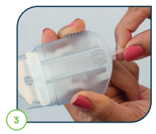 Image_of_hand_holding_the_infusion_set_on_indented_sides_and_pulling_spring_back.png